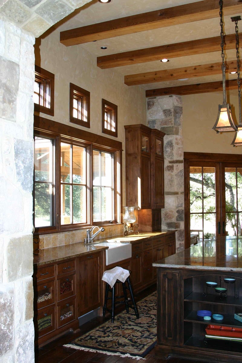 Rustic kitchen interior with wood cabinetry in a custom home by J Bryant Boyd in Georgetown, TX