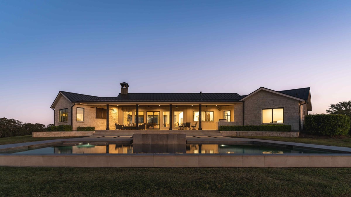 Exterior of modern central Texas house featuring a pool on a hilltop | J Bryant Boyd