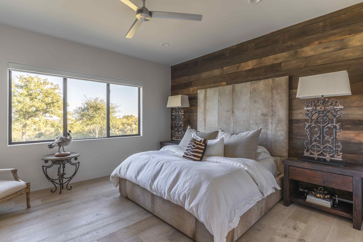 Modern central Texas bedroom with wood accent wall | J Bryant Boyd