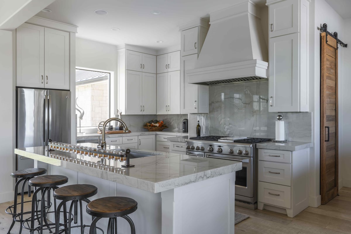 Modern kitchen with neutral color scheme and barstools | J Bryant Boyd