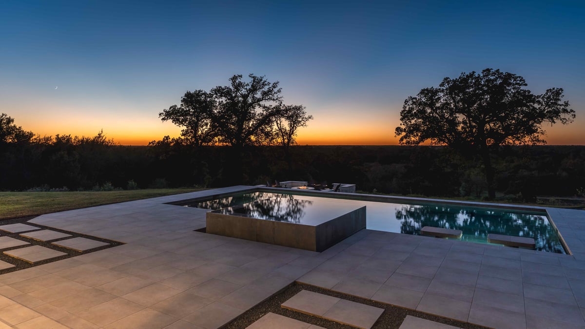 Pool underneath sunset on hilltop in central Texas | J Bryant Boyd