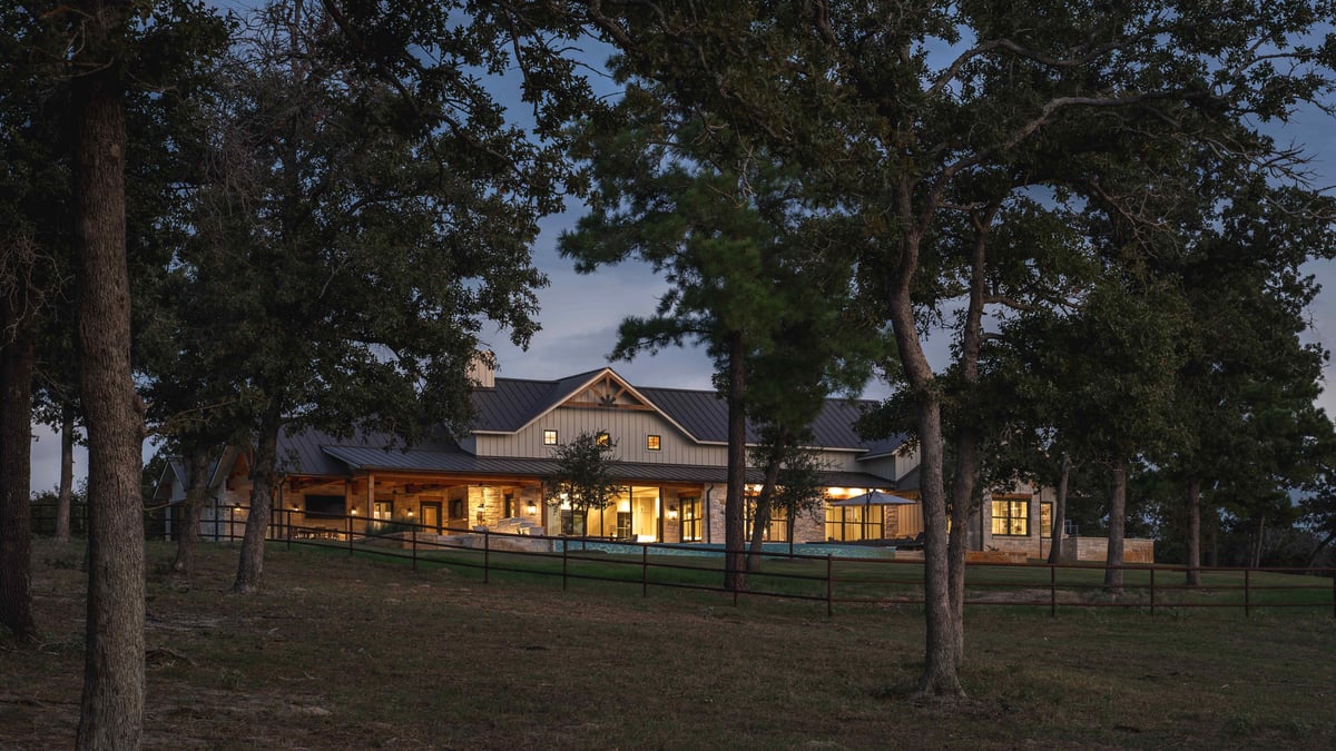 House surrounded by trees, illuminated at dusk in central Texas | J Bryant Boyd