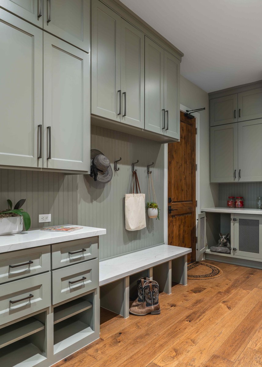 Mudroom with built-in storage, hooks for bags and hats, and a wooden bench | J Bryant Boyd