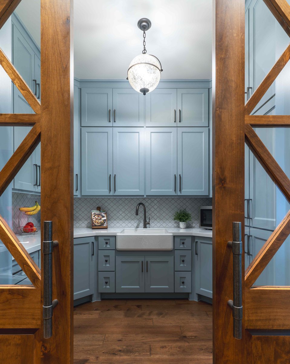 kitchen with blue cabinetry and a farmhouse sink | J Bryant Boyd