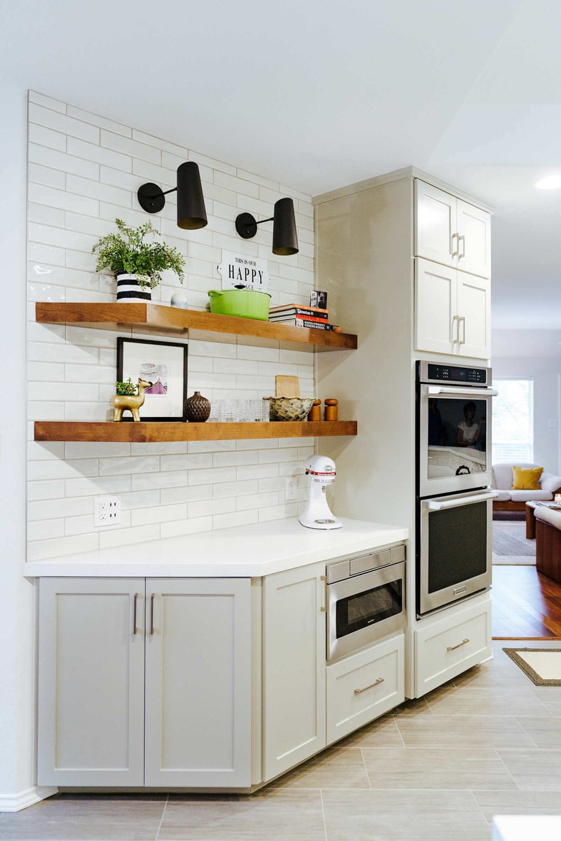 Bright kitchen remodel with white cabinets and open shelving by J Bryant Boyd in Georgetown, TX