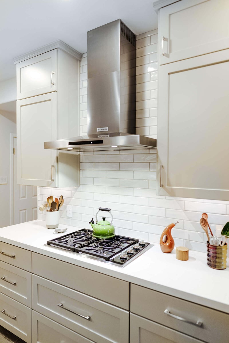 Contemporary kitchen with stainless steel range and white cabinets in Georgetown, TX, remodeled by J Bryant Boyd