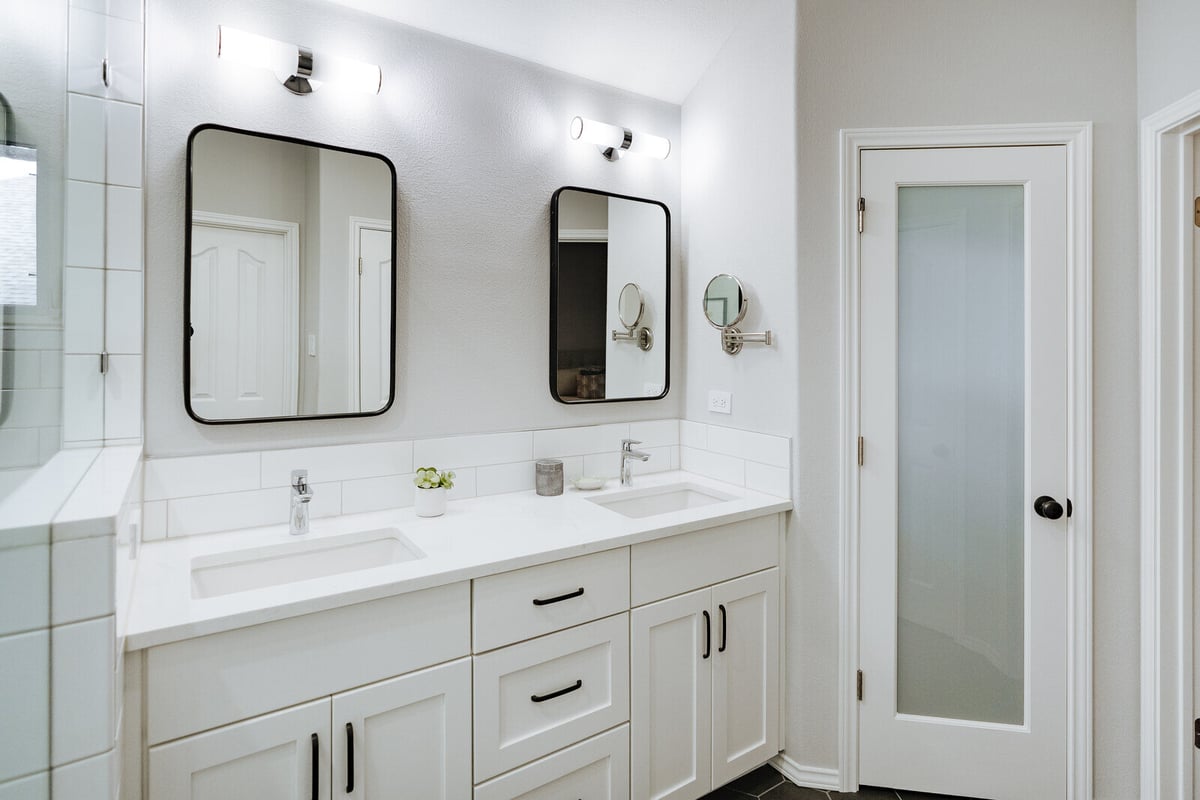 Modern bathroom with dual sinks and framed mirrors in Georgetown, TX by J Bryant Boyd