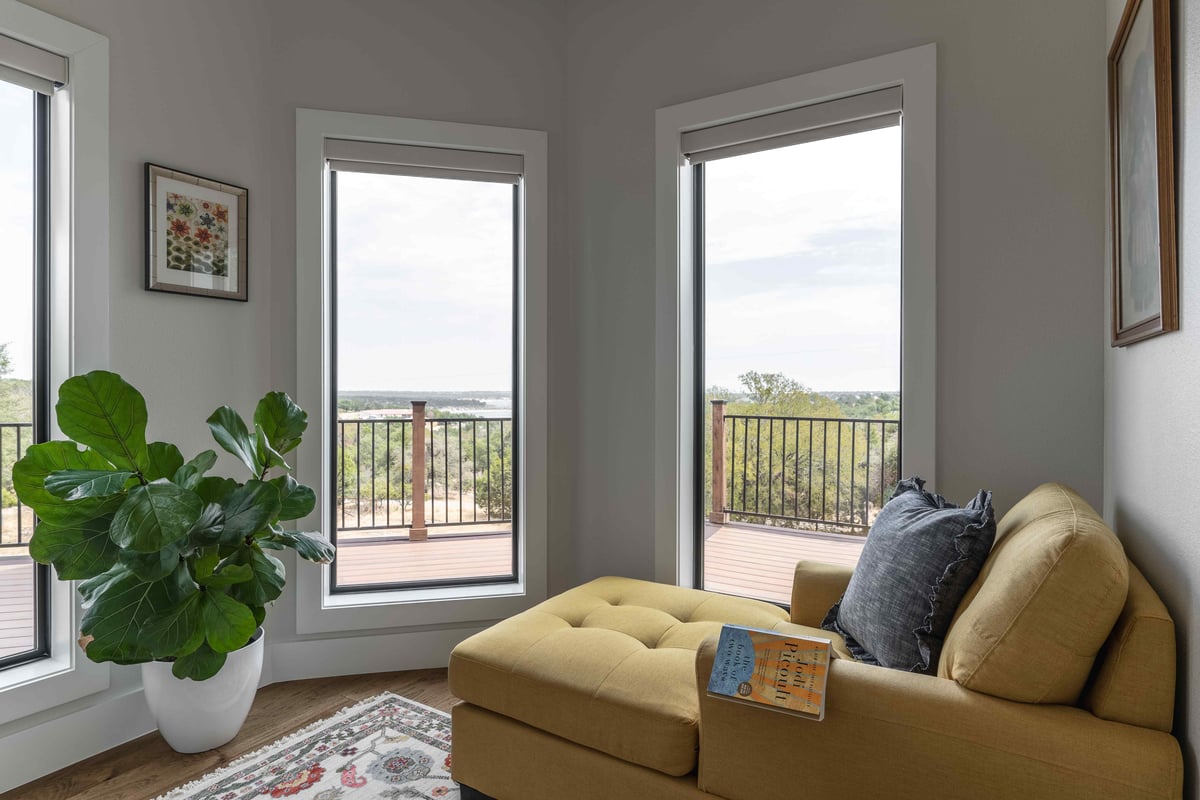 3 large windows with large fern and a reading nook | J Bryant Boyd