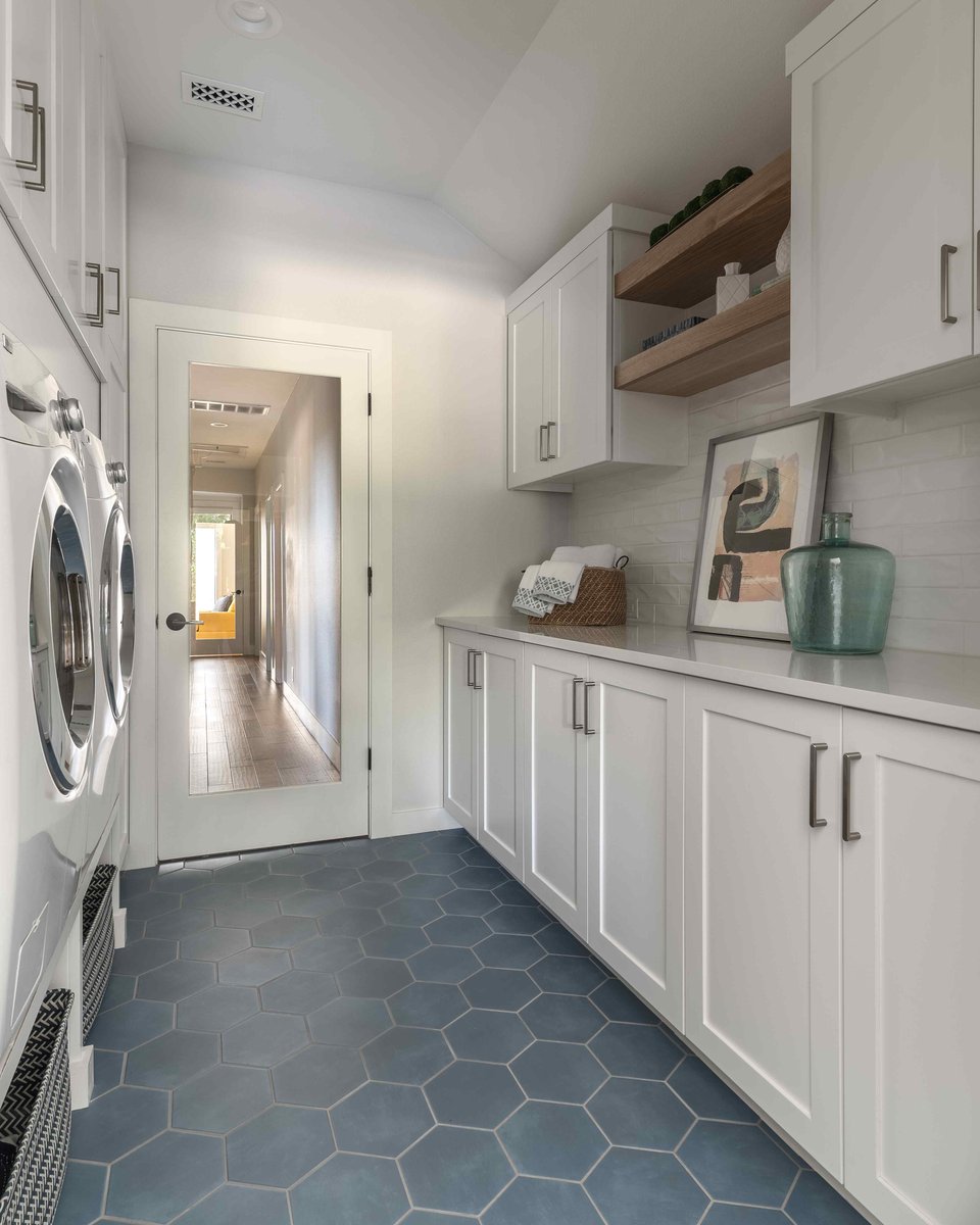 Laundry room with hex flooring and white cabinets | J Bryant Boyd