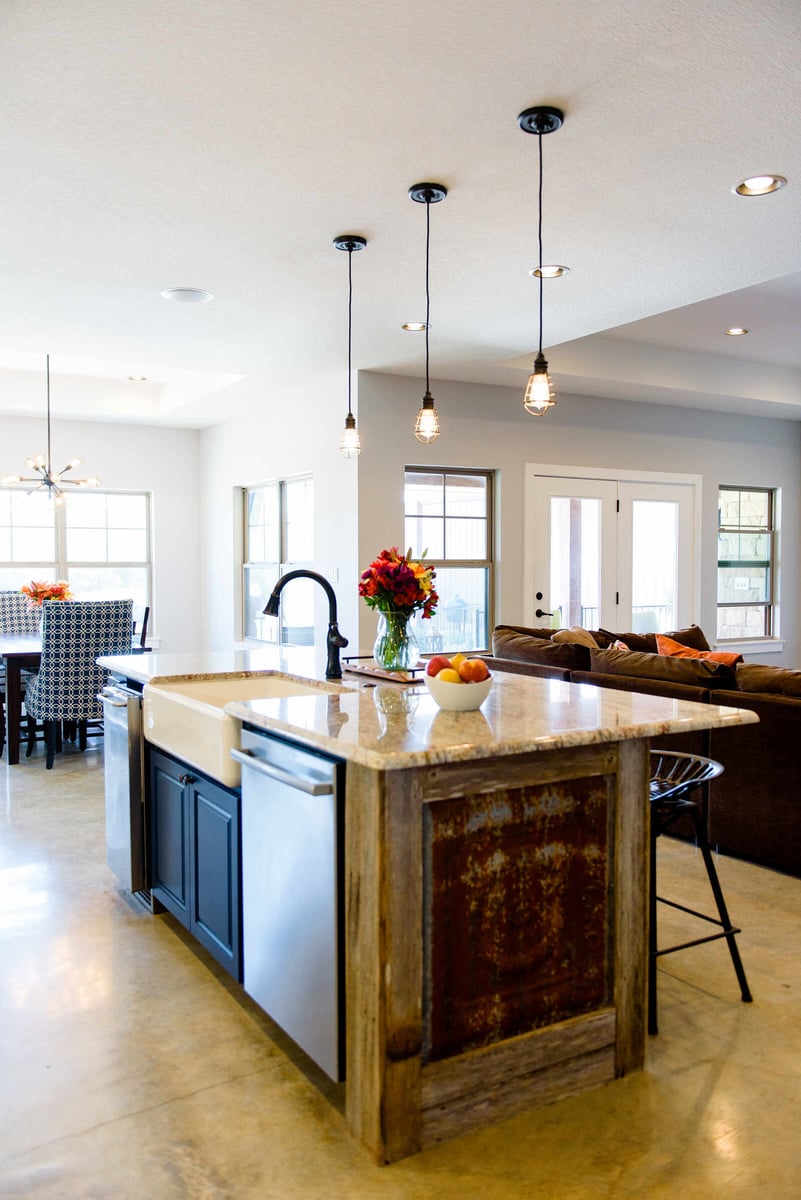 Bright dining room with large windows and stylish chandelier in a Georgetown, TX custom home by J Bryant Boyd Design-Build