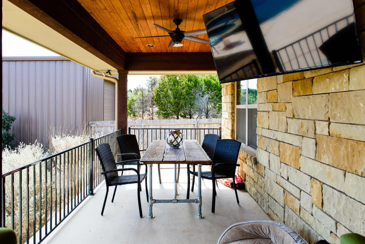 Covered patio dining area in Georgetown, TX custom home by J Bryant Boyd