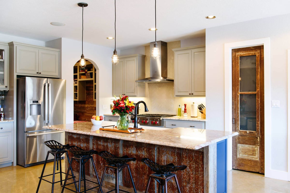 Cozy kitchen and living room space with a rustic-modern design by J. Bryant Boyd in Georgetown, TX