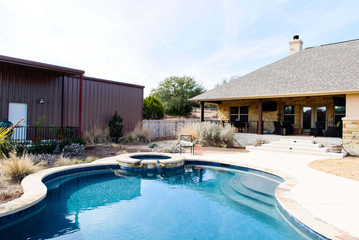 Custom home backyard with pool and patio by J Bryant Boyd in Georgetown, TX