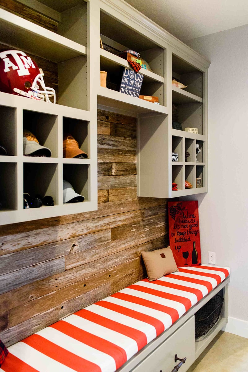 Custom mudroom storage featuring hat cubbies and rustic wood accents in a Georgetown, TX home by J Bryant Boyd Design-Build