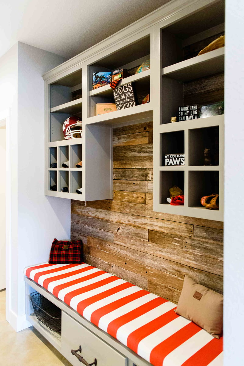 Custom mudroom with rustic wood wall and bench seating, remodeled by J. Bryant Boyd in Georgetown, TX