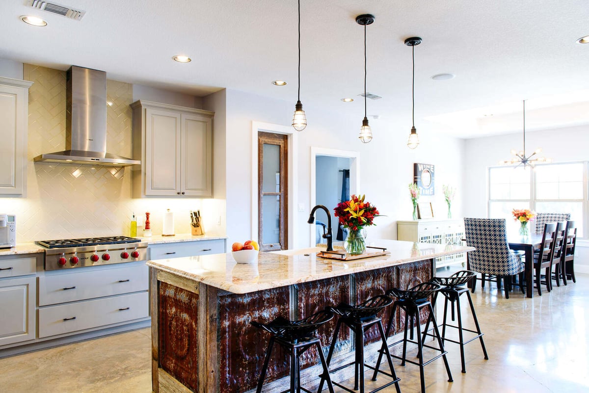 Dining room with stylish chandelier and rustic-modern decor, part of a remodel by J. Bryant Boyd in Georgetown, TX