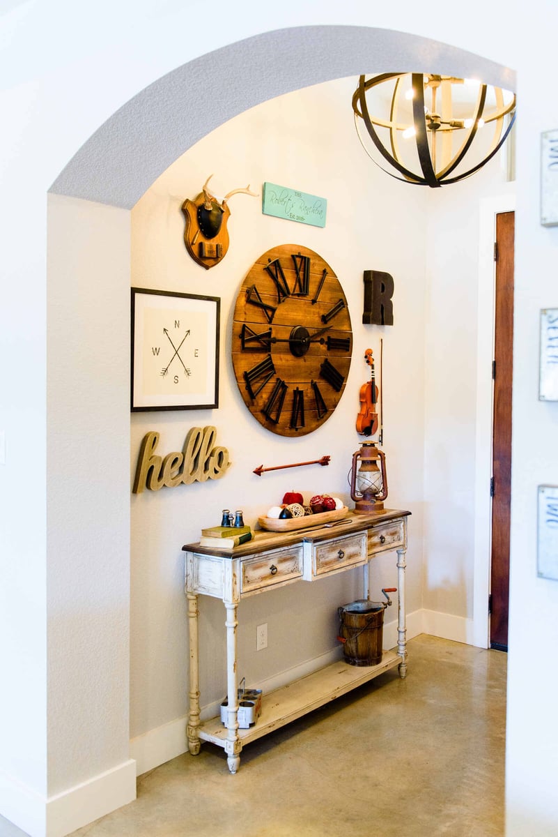 Entryway with rustic clock and vintage decor, part of a remodel by J. Bryant Boyd in Georgetown, TX