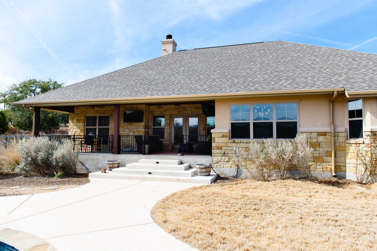 Exterior view of a custom Georgetown, TX home with stone detailing by J Bryant Boyd Design-Build