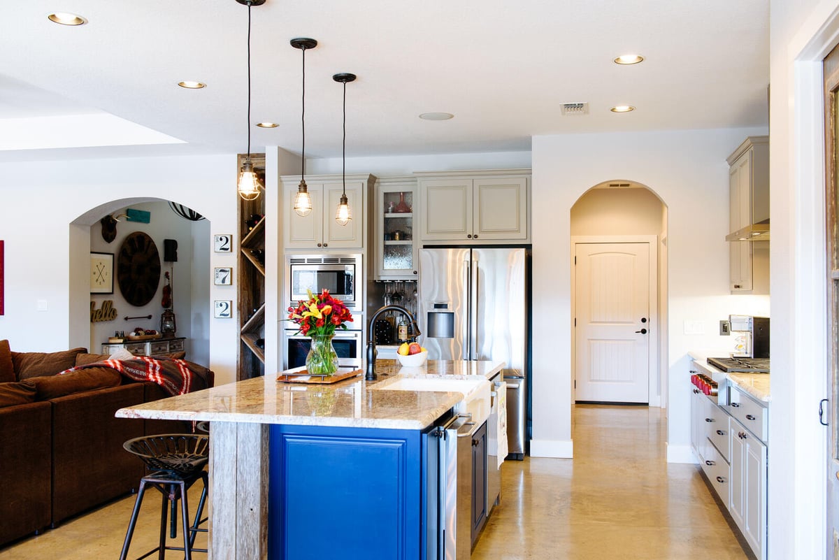 Kitchen and dining area with modern lighting and rustic accents, remodeled by J. Bryant Boyd in Georgetown, TX