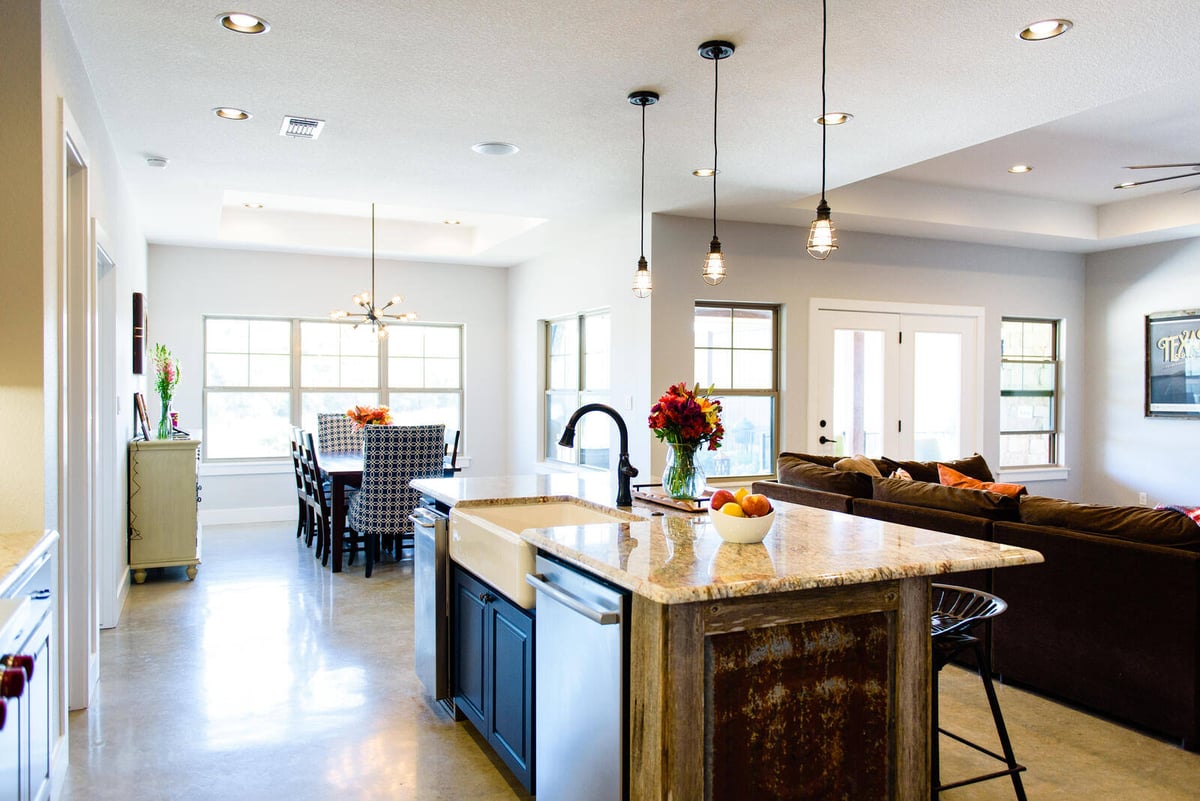 Kitchen island with rustic paneling and farmhouse sink in a Georgetown, TX custom home by J Bryant Boyd Design-Build