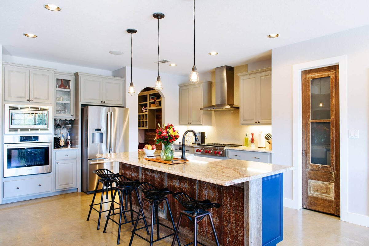 Kitchen island with seating and farmhouse sink, part of a kitchen remodel in Georgetown, TX by J. Bryant Boyd