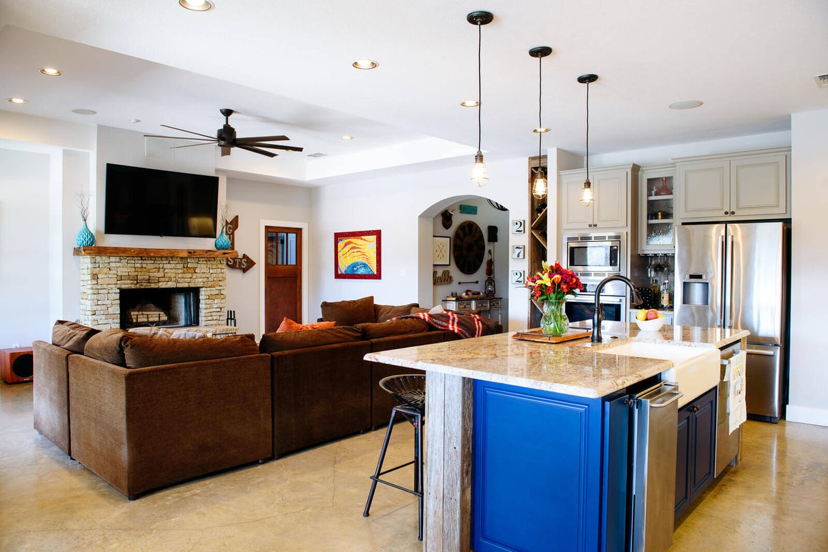 Modern kitchen with large island and farmhouse sink, part of a remodel in Georgetown, TX by J. Bryant Boyd