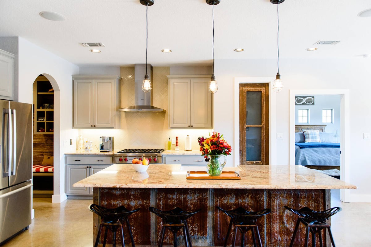 Modern kitchen with large island and pendant lighting, remodeled by J. Bryant Boyd in Georgetown, TX