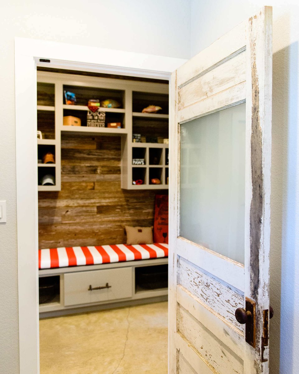 Mudroom entry with vintage door and built-in storage in a Georgetown, TX custom home by J Bryant Boyd