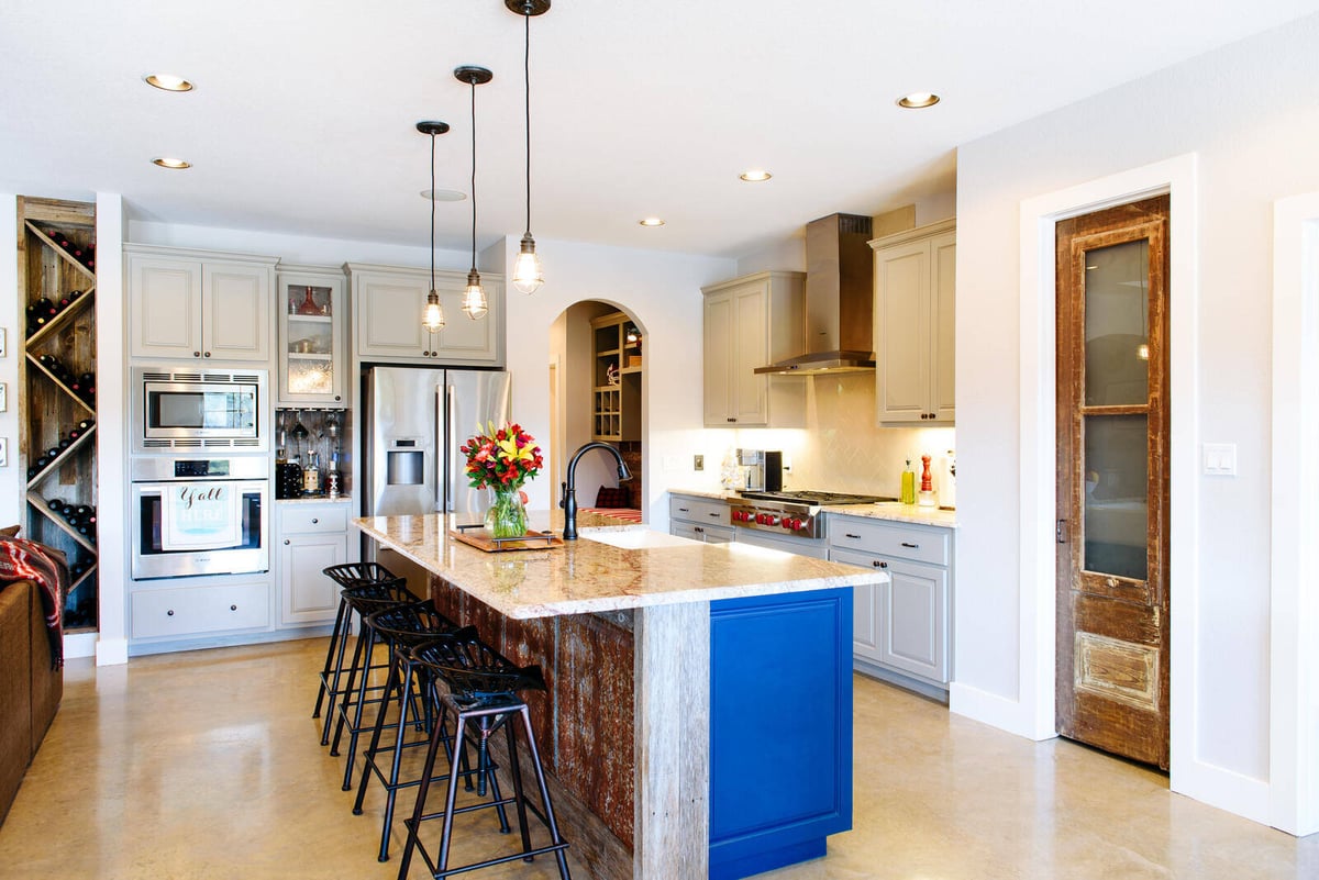 Open-concept kitchen featuring a large island and pendant lighting, remodeled by J. Bryant Boyd in Georgetown, TX