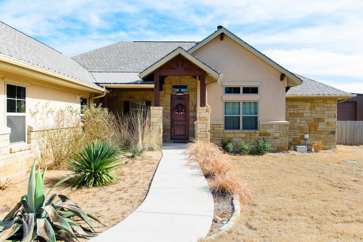 Pathway leading to the front entrance of a custom home by J Bryant Boyd, Georgetown, TX