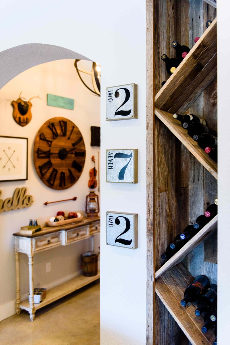 Rustic-modern wine rack and hallway decor, part of a remodel by J. Bryant Boyd in Georgetown, TX
