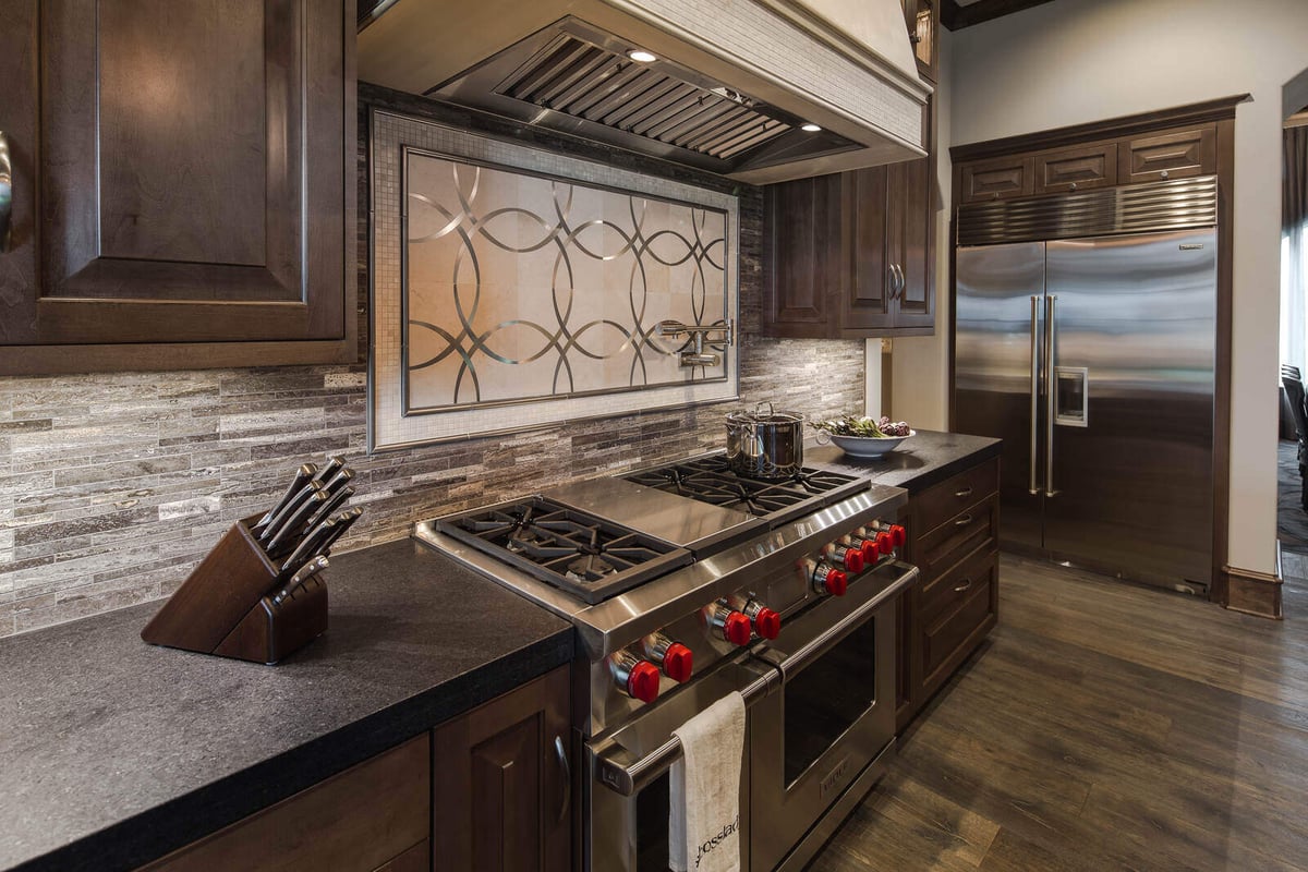 Close-up of luxury kitchen stove area with custom tile backsplash in a J Bryant Boyd home, Georgetown, TX