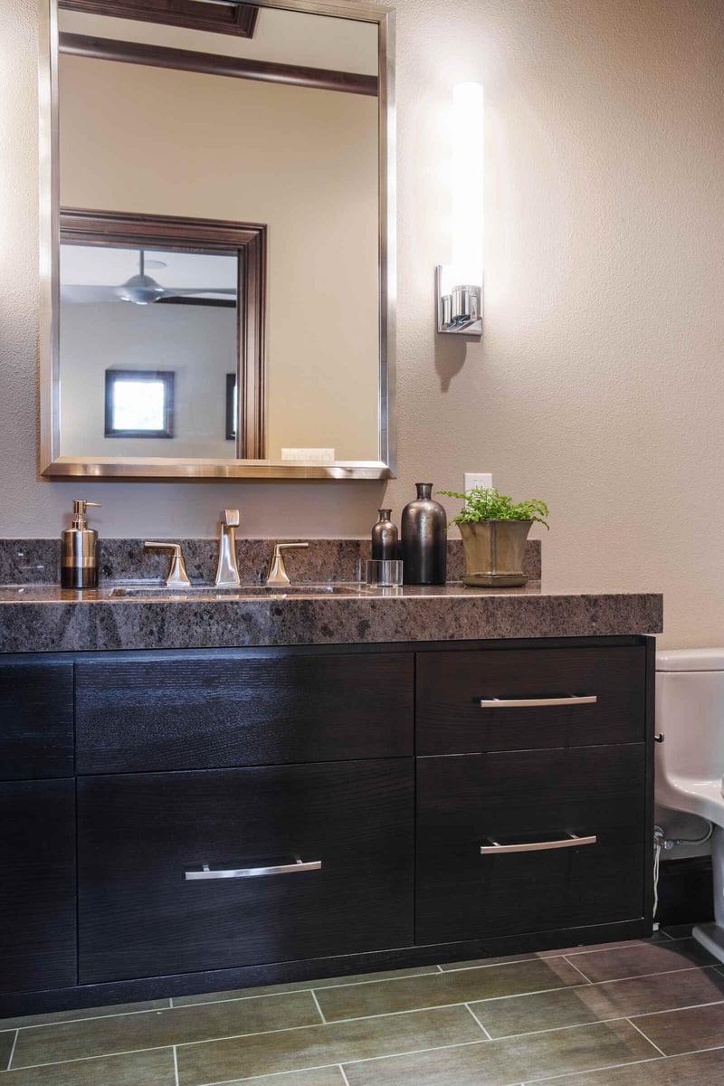 Contemporary custom home bathroom by J Bryant Boyd in Georgetown, TX, featuring a sleek vanity with modern fixtures