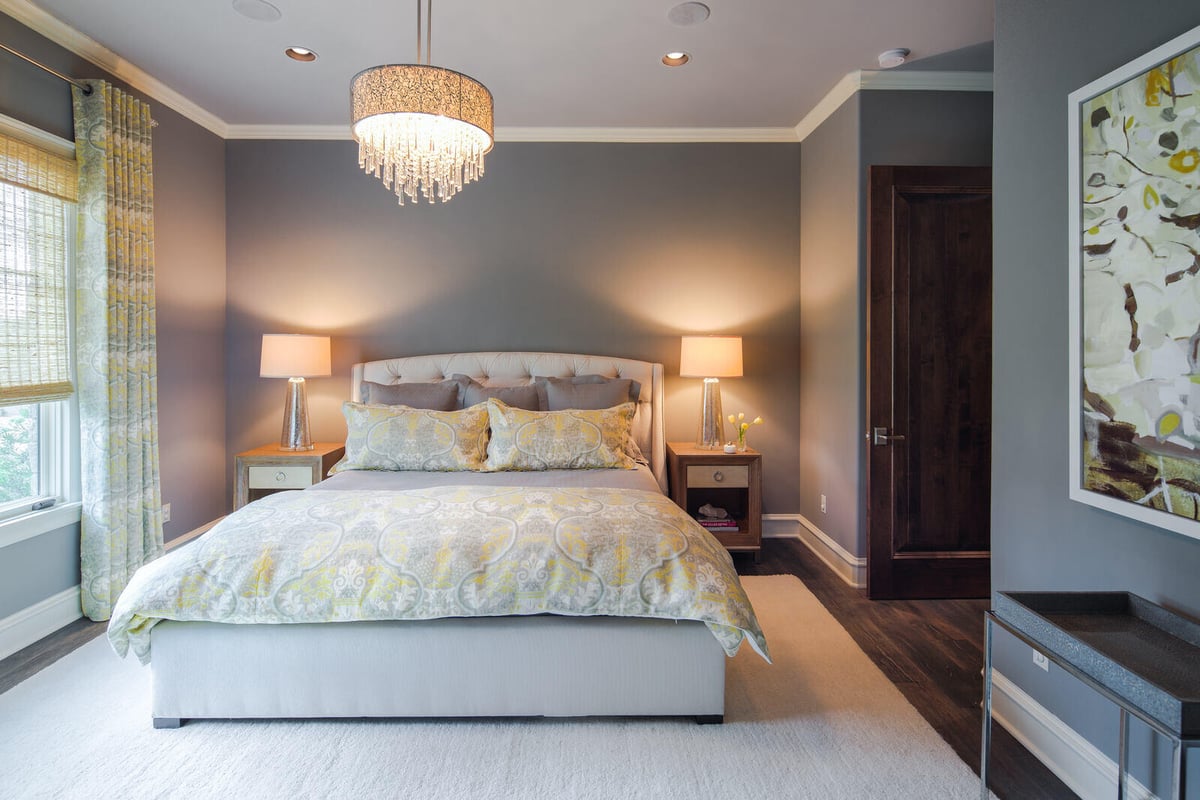 Cozy master bedroom with chandelier in a custom home by J Bryant Boyd in Georgetown, TX