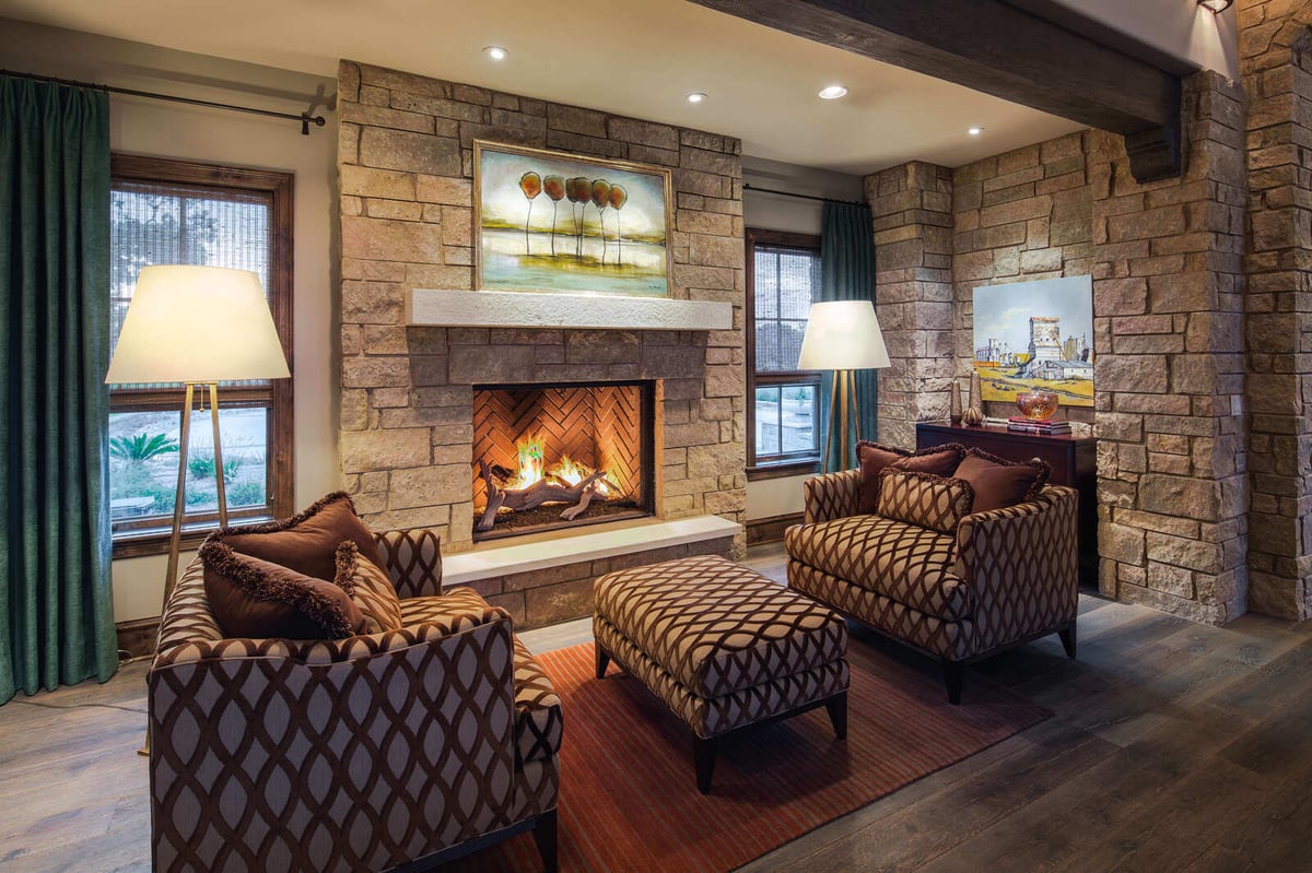Cozy sitting area with a stone fireplace in a custom home by J Bryant Boyd in Georgetown, TX