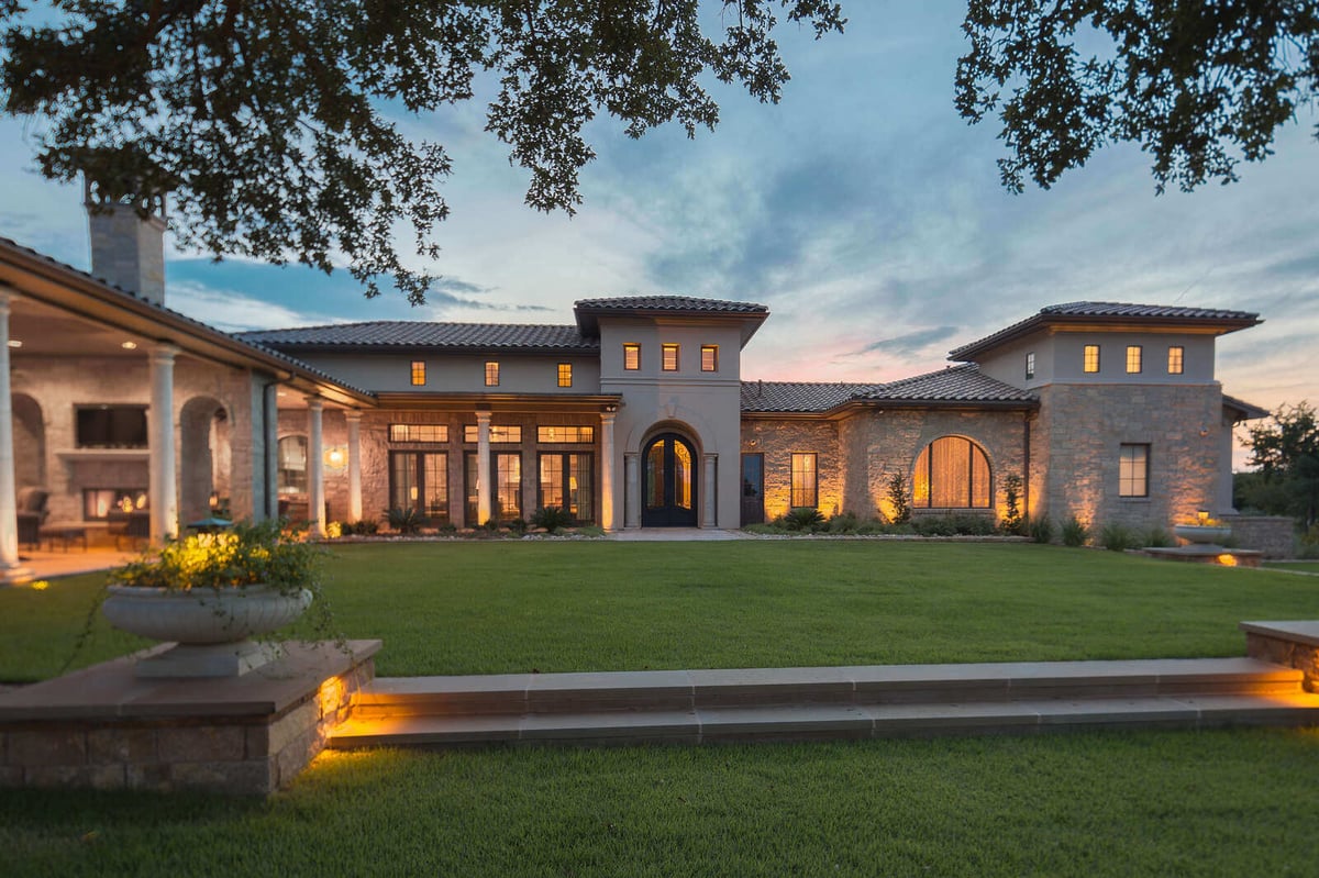 Custom Mediterranean-style home with expansive lawn and stone columns in Georgetown, TX by J Bryant Boyd