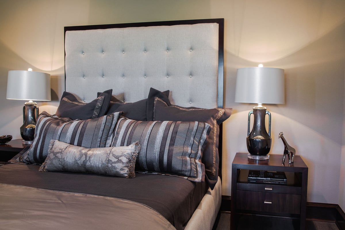 Custom home bedroom with modern design and upholstered headboard by J Bryant Boyd in Georgetown, TX