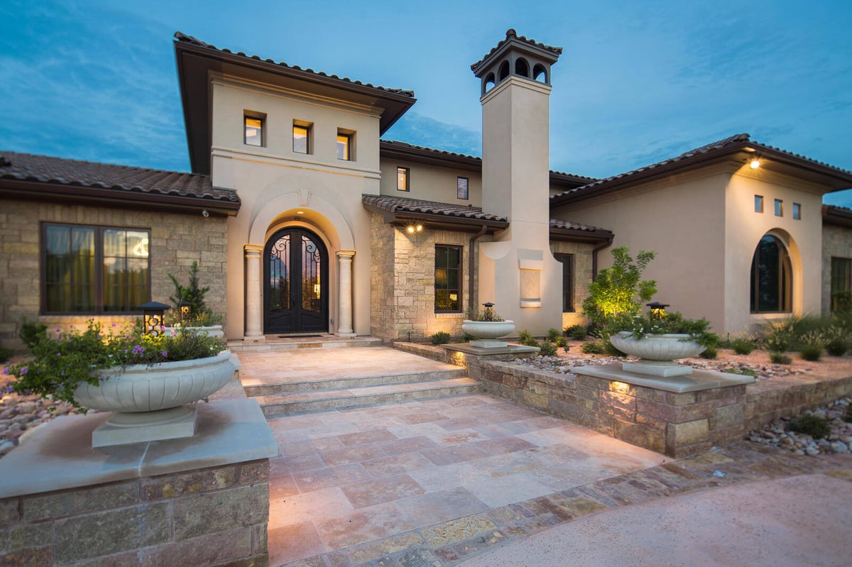 Custom home entrance with stone steps and landscaping in Georgetown, TX by J Bryant Boyd
