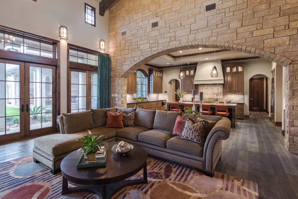 Custom living room with large windows and a view of the kitchen by J Bryant Boyd, Georgetown, TX