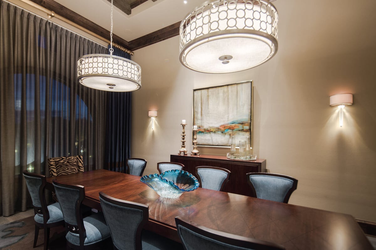 Dining room with elegant chandelier lighting and modern decor in a custom home by J Bryant Boyd in Georgetown, TX