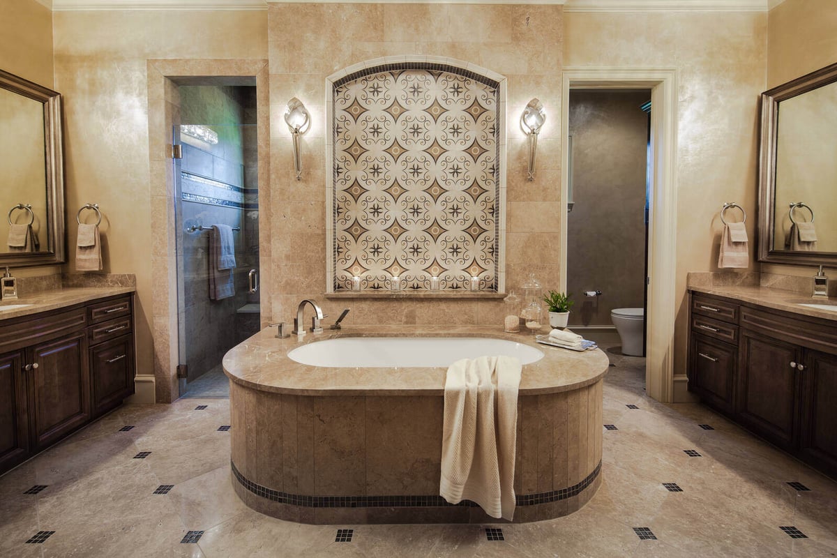 Elegant bathroom with centerpiece bathtub in a custom home by J Bryant Boyd in Georgetown, TX