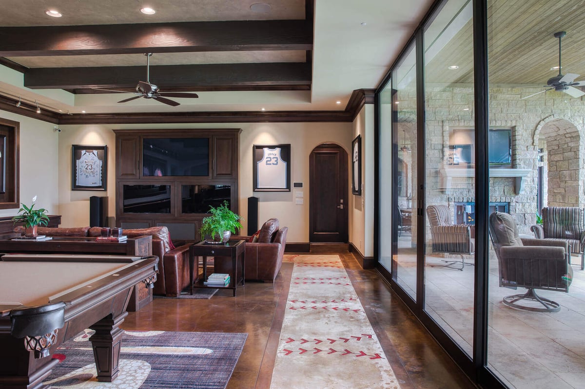 Game room with a pool table and leather seating area in a custom home by J Bryant Boyd, Georgetown, TX