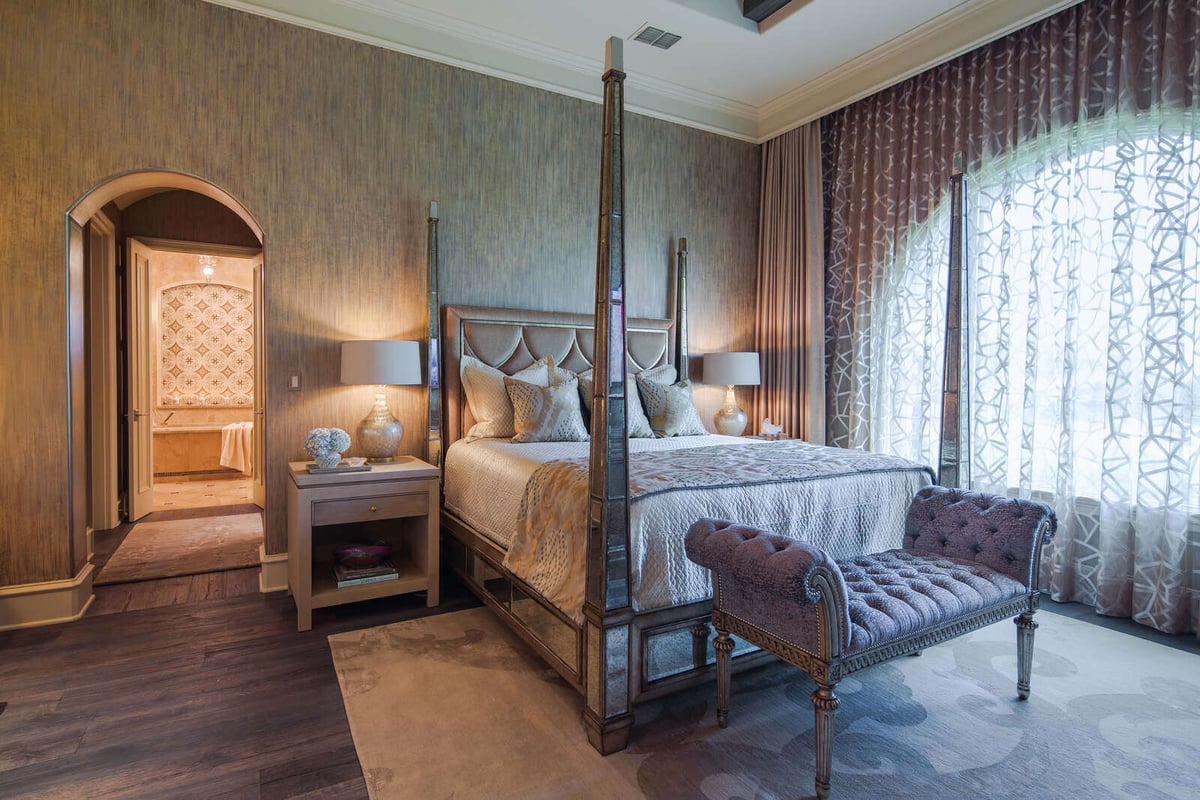 Luxurious master bedroom with draped windows in a custom home by J Bryant Boyd in Georgetown, TX