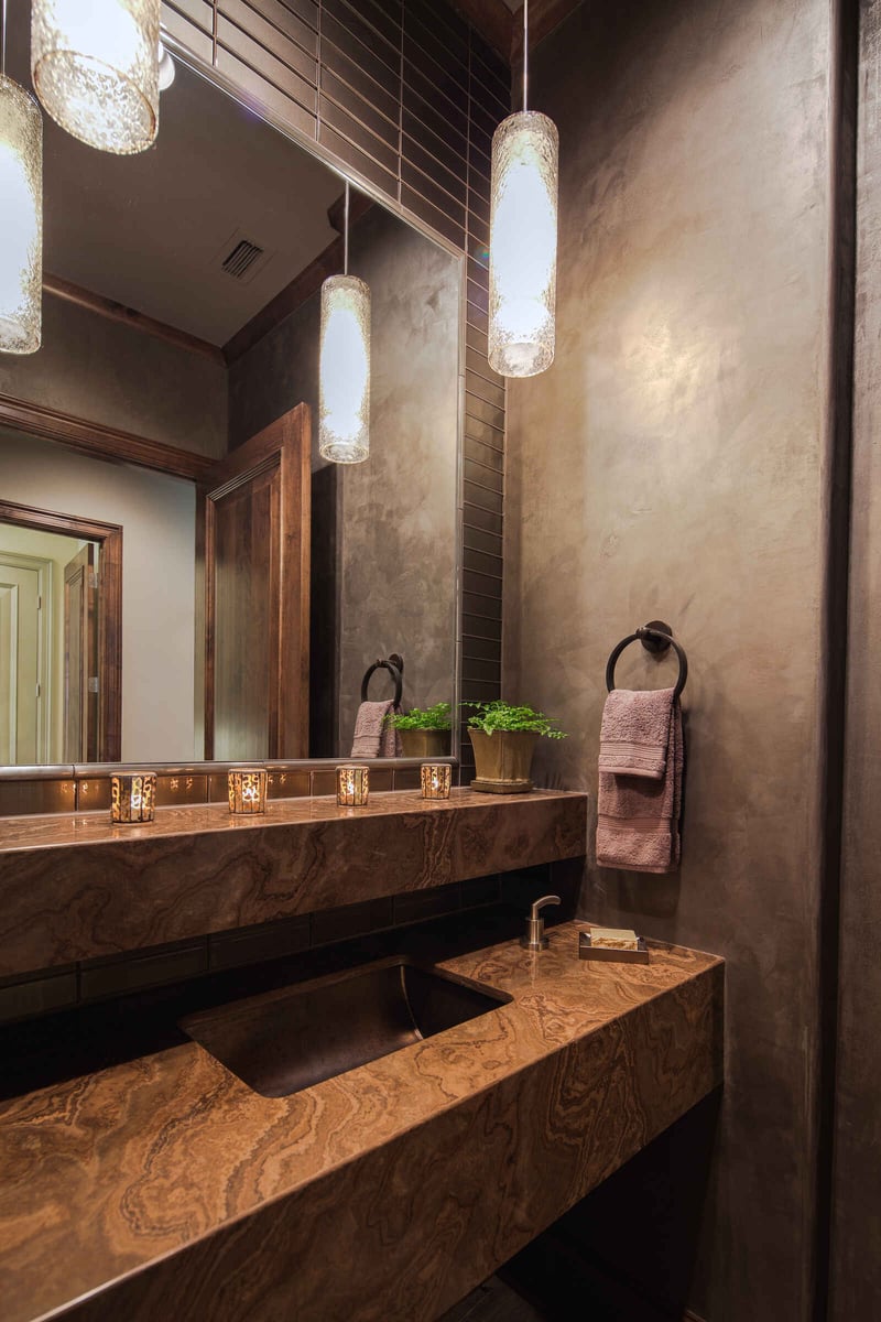 Luxurious powder room with marble countertop in a custom home by J Bryant Boyd in Georgetown, TX