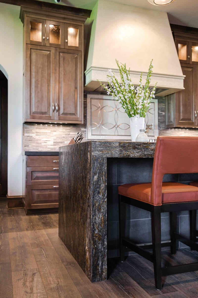 Rustic kitchen island with granite countertop in a custom home by J Bryant Boyd in Georgetown, TX