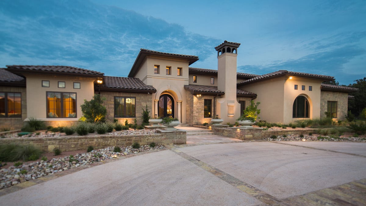 Stunning custom home exterior by J Bryant Boyd in Georgetown, TX, featuring elegant architecture and beautifully landscaped front yard