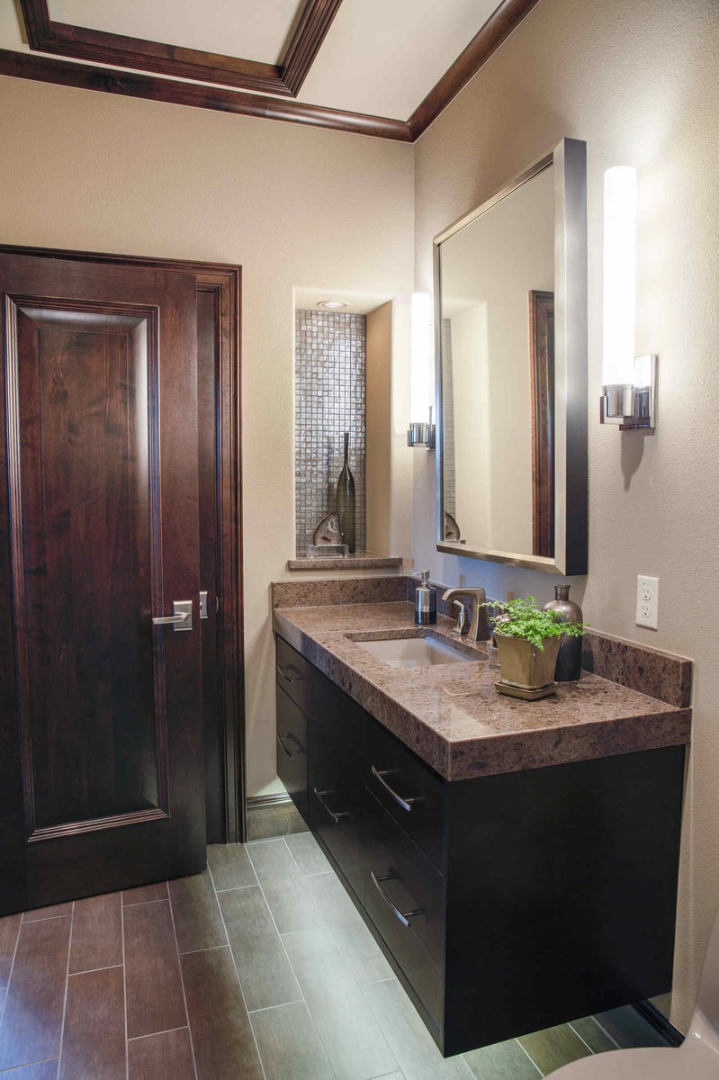 Stylish custom home bathroom vanity by J Bryant Boyd in Georgetown, TX, featuring a sleek countertop and contemporary lighting