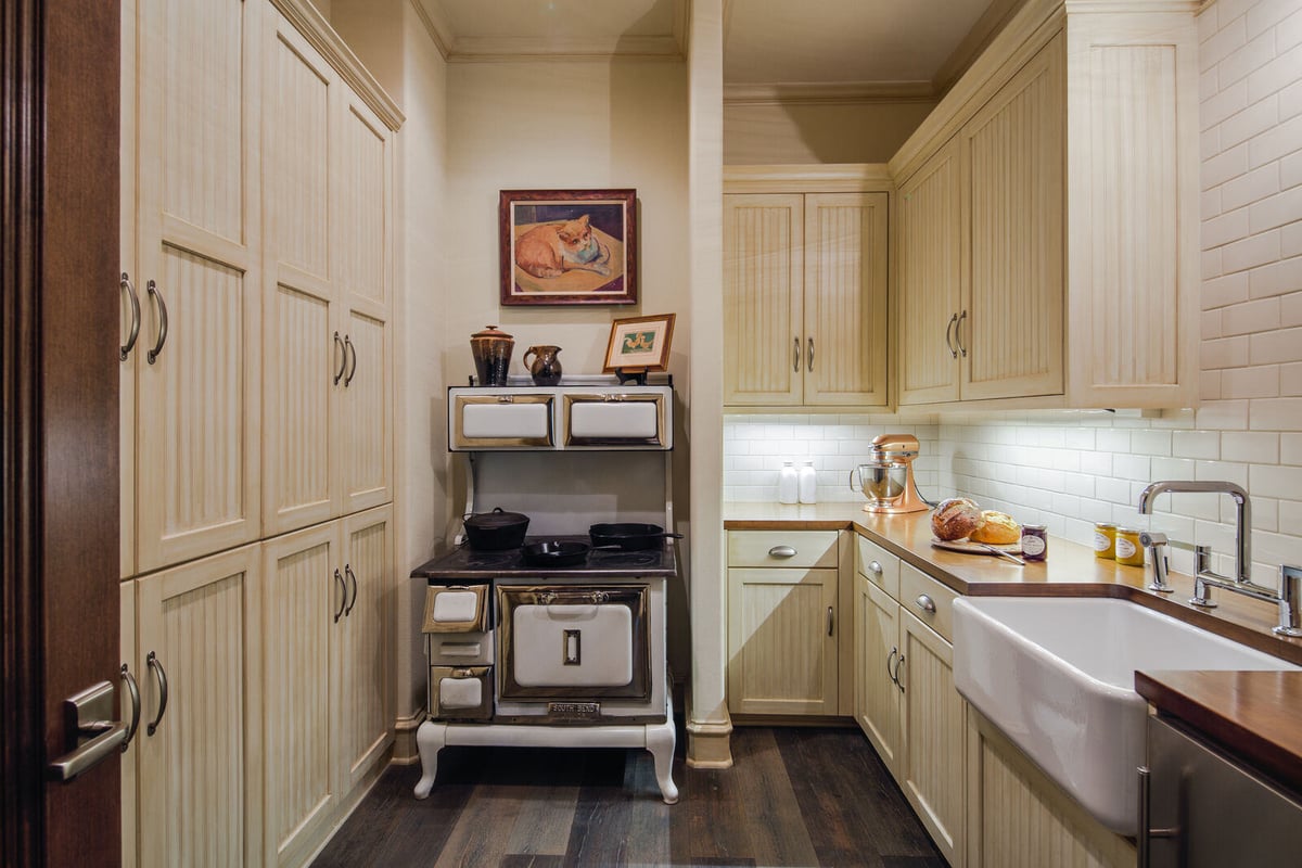 Vintage-inspired pantry with antique stove in a custom home by J Bryant Boyd in Georgetown, TX