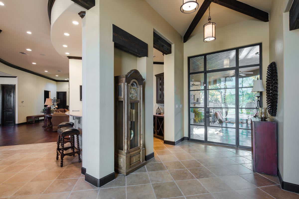 Custom home hallway with a tall grandfather clock by J Bryant Boyd in Georgetown, TX