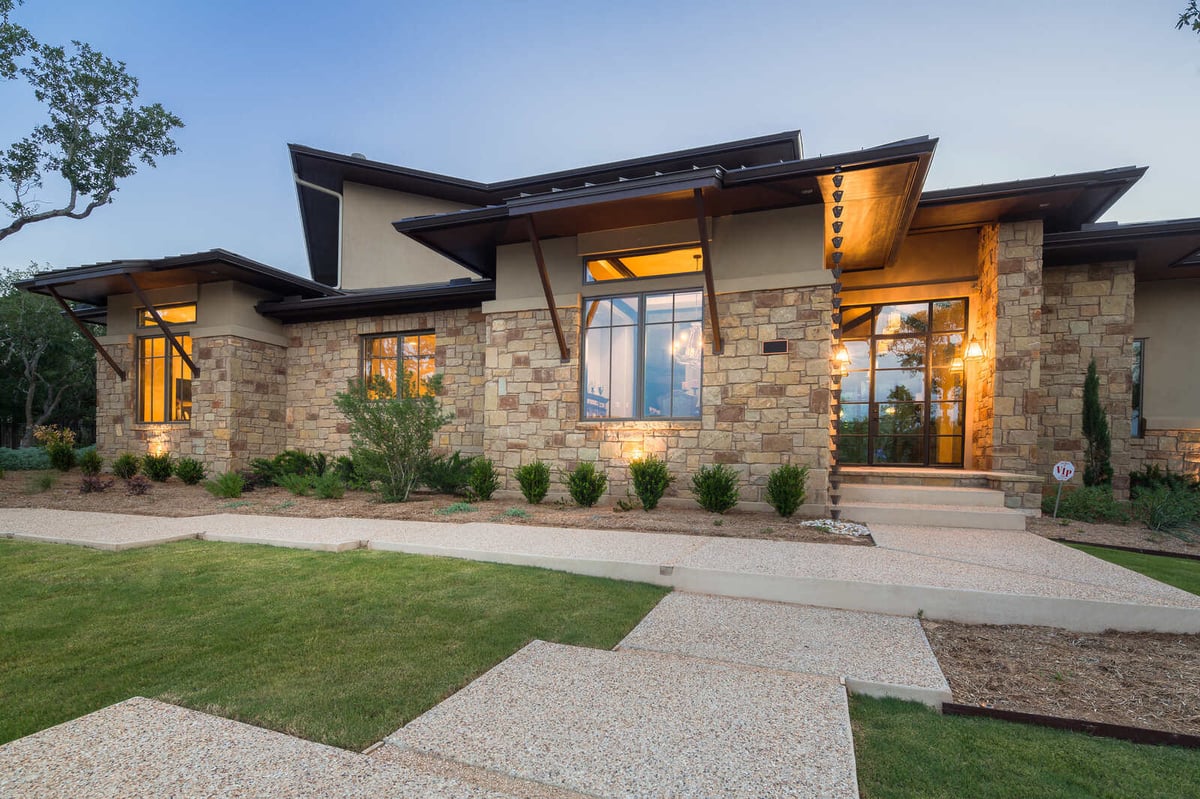 Exterior view of a custom stone home by J Bryant Boyd in Georgetown, TX